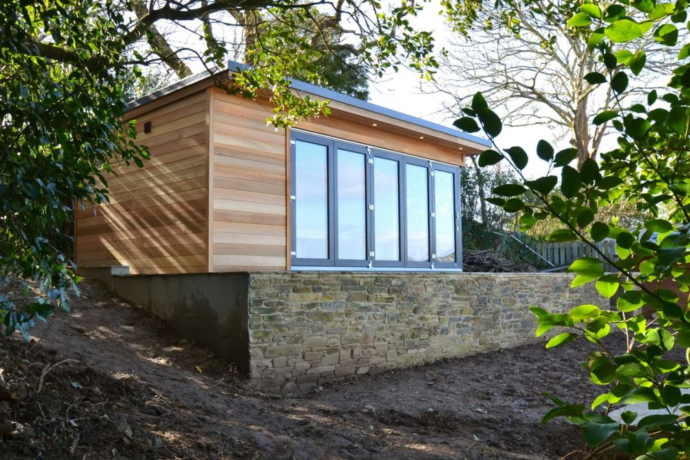 The garden room is raised on block and stone retaining walls